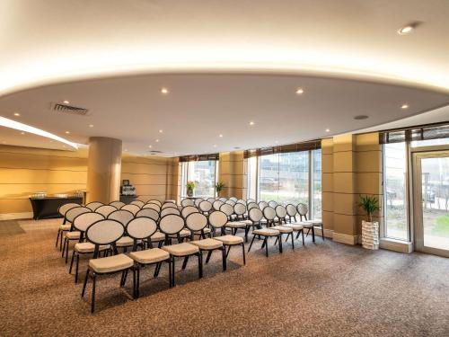 a room with a bunch of chairs and tables at Sofitel Luxembourg Europe in Luxembourg