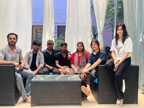 a group of people sitting on a bench at Nani s House - Warmth & Comfort in Dehradun