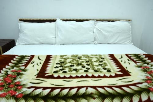a bed with a blanket on top of it at maa kalishila home stay in Ukhimath