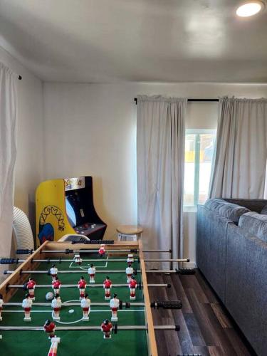 a living room with a table with soccer balls on it at Modern Cabin with Arcade, Foosball Table and Fire Pit in Meadview, Arizona in Meadview