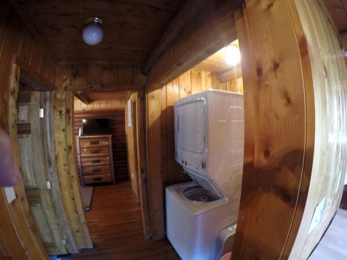 a bathroom with a washing machine and a tv at Traditional Log Cabin Rental near the Grand Tetons in Alpine, Wyoming in Alpine