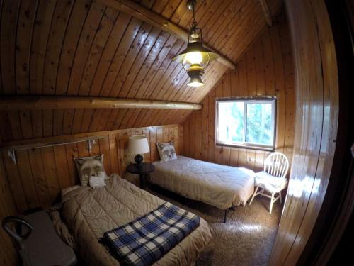 a room with two beds in a log cabin at Traditional Log Cabin Rental near the Grand Tetons in Alpine, Wyoming in Alpine