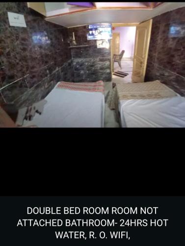 Postel nebo postele na pokoji v ubytování Evergreen Residency Dwarka