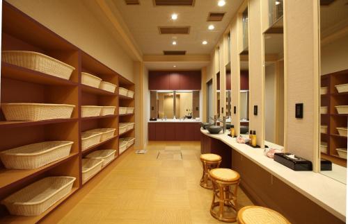 a library with wooden shelves and stools at Kinparo in Kyoto