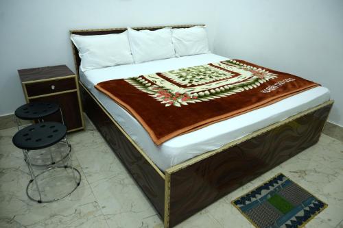 a bedroom with a bed with a wooden frame at maa kalishila home stay in Ukhimath