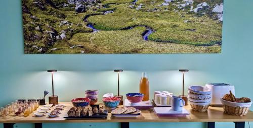 a table with cookies and other items on it at Balcons de Sorgeat - Chambres d'hôtes - Ecolodge en montagne in Sorgeat