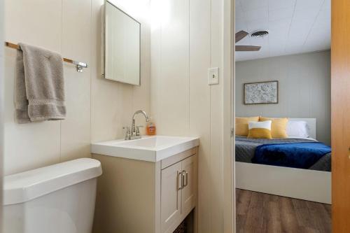 a small bathroom with a sink and a bed at Spacious Chic Cabin with Private Yard in Marble Falls, Texas in Smithwick