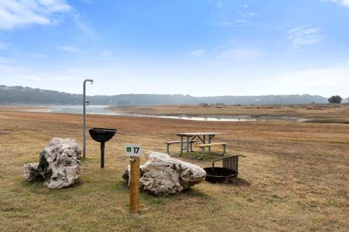 a park with a picnic table and a rock at Spacious Chic Cabin with Private Yard in Marble Falls, Texas in Smithwick