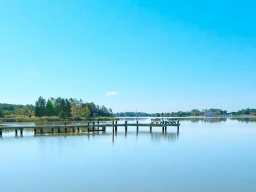 a dock in the middle of a large body of water at Family-Friendly Waterfront Getaway with a Swimming Pool and Dock in Cambridge, Maryland in Cambridge