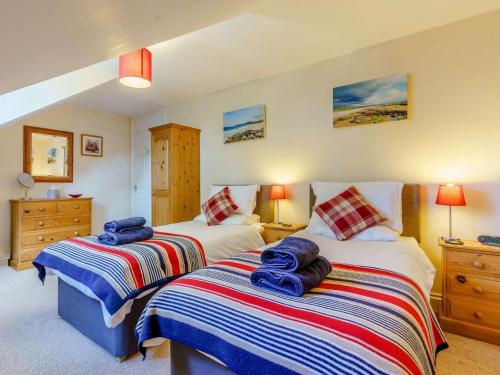 a bedroom with two beds with towels on them at 2 bed in Totland Bay IC003 in Freshwater