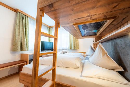 a bedroom with a bunk bed with a ladder at Försterhaus & Haus Andrea in Mayrhofen