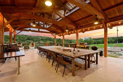 a large dining room with a large wooden table at Entire Property Rental for Large Groups Sleeping 40+ Guests with Pool and Fire Pit in Texas Hill Country near Austin, Texas in Hammetts Crossing