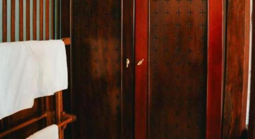 a wooden door in a room with a towel at Jun's Home in Buon Ma Thuot