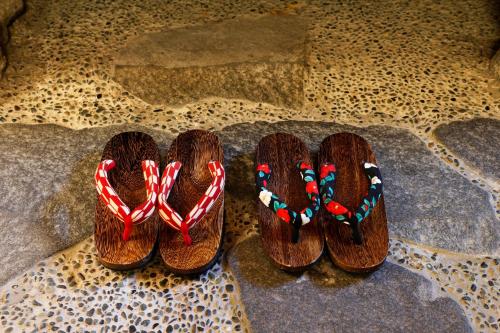 a pair of shoes with candy canes on the floor at Sennentei in Yurihama