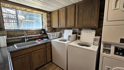 a kitchen with a washer and dryer and a sink at Waterfront Vacation Rental for Two Guests near Ohiopyle State Park, Pennsylvania in Confluence
