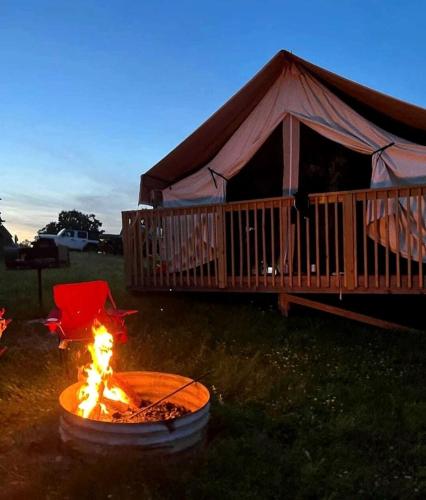 a fire pit in front of a gazebo at Hocking Hills Deluxe Safari Glamping Tents in Logan