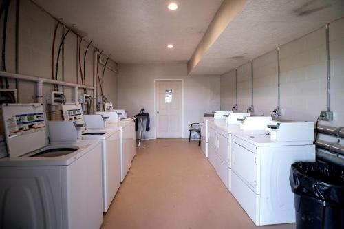 a large laundry room with white washers and dryers at Hocking Hills Deluxe Safari Glamping Tents in Logan
