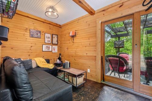 a living room with a couch and a window at Unique Dover Accommodation with a Hot Tub Perfect for Glamping in Ohio in Mineral City