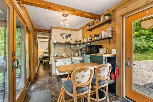 a kitchen and dining room of a tiny house at Unique Dover Accommodation with a Hot Tub Perfect for Glamping in Ohio in Mineral City