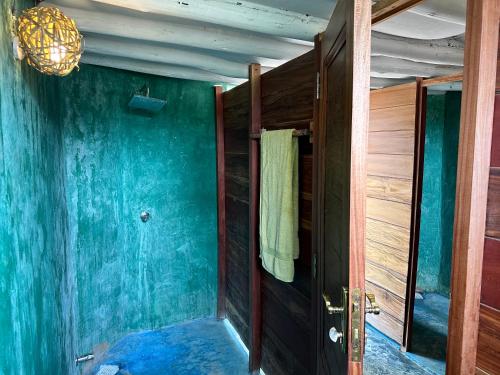 a room with blue walls and a door with a towel at Kameleon Blue in Kizimkazi