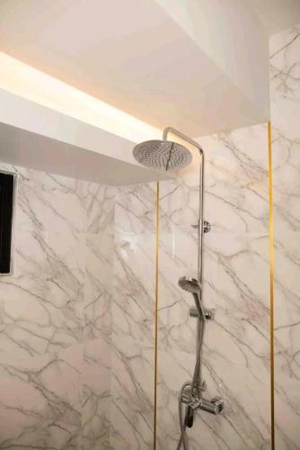 a shower in a bathroom with a marble wall at Pool Villa Suchada 3 bedrooms max 7 peoples in Ban Khlong Haeng