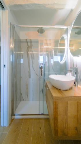 a bathroom with a glass shower and a sink at Casa Vacanze - Il Gelso in Collevecchio