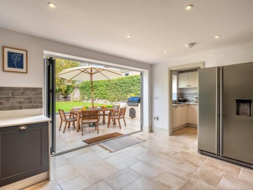 a kitchen and dining room with a table with an umbrella at 4 bed in Crickhowell 85242 in Crickhowell