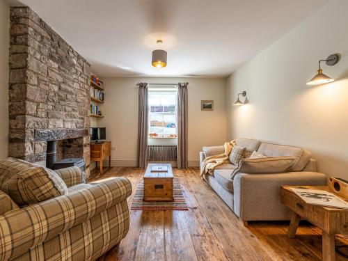 a living room with two couches and a stone fireplace at 4 bed in Crickhowell 85242 in Crickhowell