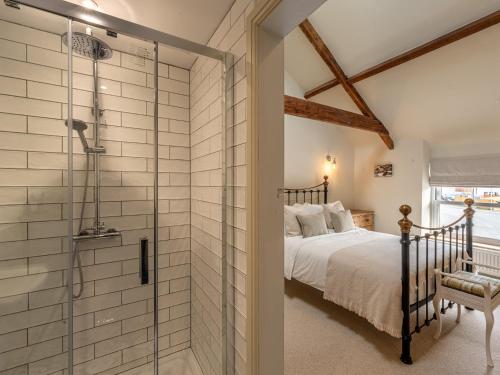 a master bedroom with a shower and a bed at 4 bed in Crickhowell 85242 in Crickhowell