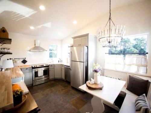 a kitchen with a refrigerator and a table in it at Idyllic Waterfront Rental with Shared Pool Access in Jupiter, Florida in Delta