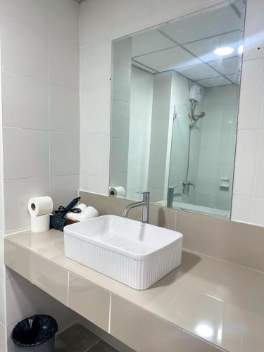 a white bathroom with a sink and a mirror at View Talay6 by Blue Ocean Suite in Pattaya Central
