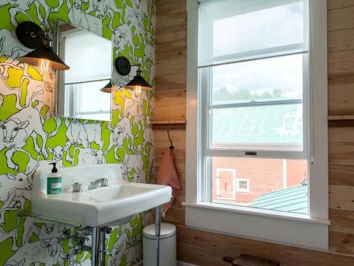 a bathroom with a sink and a window at Modern Luxury Farmhouse with a Jacuzzi Tub near Woodstock, Vermont in Bridgewater