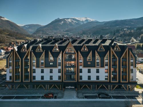 an aerial view of a building with mountains in the background at Wulfenia Hotel & Spa in Kolašin