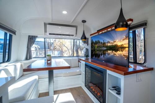 a living room with a tv and a fireplace in an rv at Airstream Escape Near Granite Creek in Prescott, Arizona in Prescott