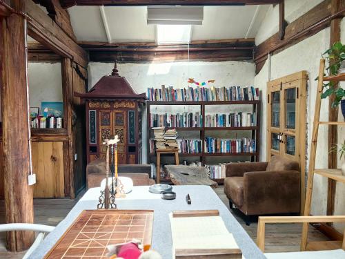 a living room with a couch and a table at Dali Xizhou Jiakedi 大理喜洲甲科第古宅文化民宿 in Dali