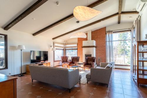 a living room with chairs and a table at Tahko Golden Resort in Tahkovuori