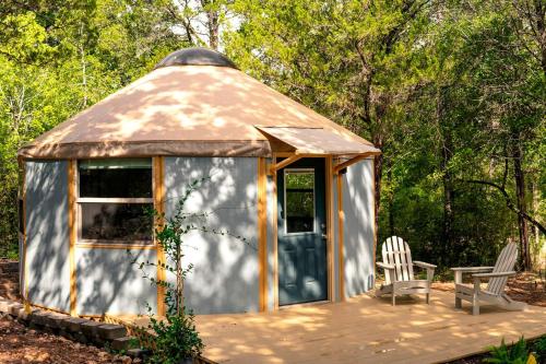 a gazebo with two chairs and a table at Stunning Yurt Rental in Texas Ideal for a Romantic Getaway near Austin in Bastrop