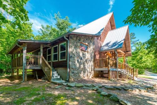 a log cabin with a porch and decks at Lovely Cabin with Hot-tub and Fireplace in Cleveland, Georgia in Kinseytown