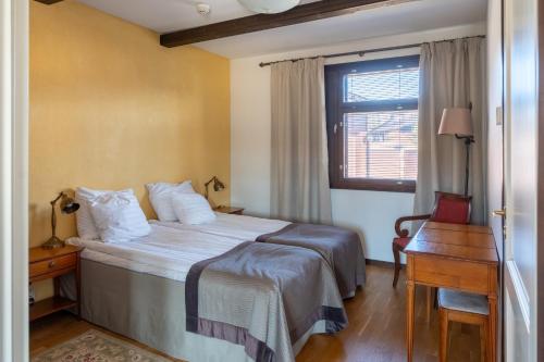 a hotel room with a bed and a window at Tahko Golden Resort in Tahkovuori