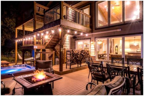 a house with a patio with a fire table and chairs at Luxurious Villa with Hot-tub, Fire Pit and Games in Gary, Indiana in Miller