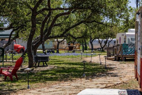 a park with a hammock under a tree at Fabulous Cozy Airstream Perfect for a Small Family Unique Escape in Texas in Spicewood
