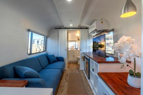 a living room with a blue couch and a kitchen at Wagon Circle Unit in Prescott, AZ in Prescott