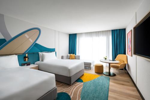 a hotel room with a bed and a desk at M Social Hotel Phuket in Patong Beach