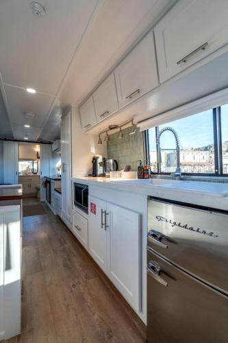 a large kitchen with white cabinets and a large window at Wagon Circle Unit in Prescott, AZ in Prescott