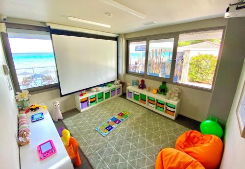 a childs room with a large screen and the ocean at Ammon Zeus Luxury Beach Hotel in Kallithea Halkidikis