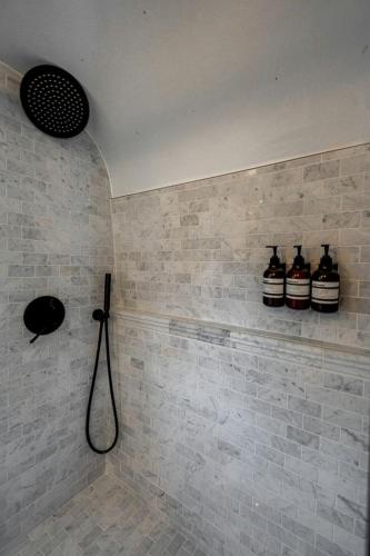 a bathroom with three bottles on the wall at Wagon Circle Unit in Prescott, AZ in Prescott