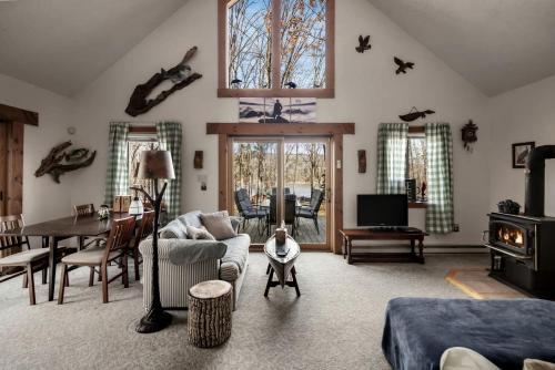 a living room with a couch and a table at Lustrous Lakefront Cabin Oasis near Lake Ferndale in West Virginia in Springfield