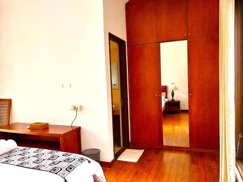 a bedroom with a bed and a wooden closet at Villa Sabasanti Gianyar in Keramas