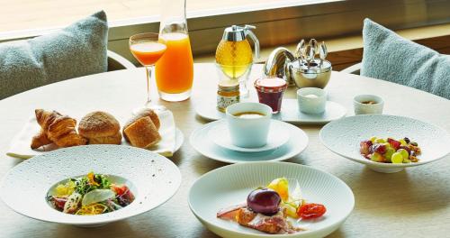 a table topped with plates of food and drinks at UMITO Kamakura Koshigoe in Kamakura