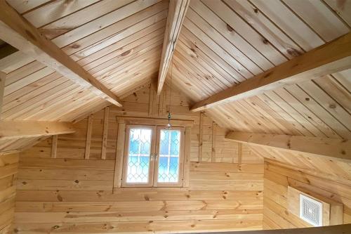 a room with a wooden ceiling and a window at Remote and Serene Lakefront Cabin in Cantwell, Alaska, with Gorgeous Views of Nations Mountain in Cantwell